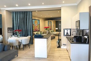 Ein modernes Apartment mit Essbereich, Wohnzimmer und Küche.