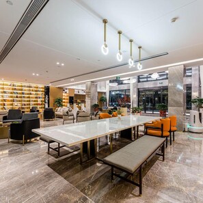 A modern library with a marble floor, a long table, and several chairs. - Shengzhou Atour Hotel (Shaoxing)