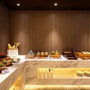 A breakfast buffet with various food items and beverages.