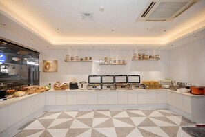 A modern kitchen with white cabinets, a tiled floor, and various appliances and food items on the counter. - Borrman Hotel Canton Tower Sun Yat Sen University Metro Station Pazhou Exhibition Center (Guangzhou)