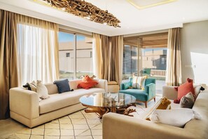 A modern living room with a sofa, armchairs, and a coffee table. - Tulum Beach Resort & Spa Dakhla (Dakhla)