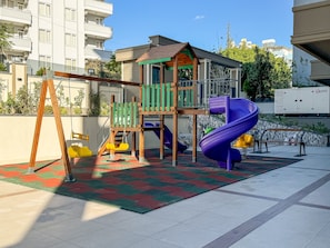 A playground with a slide, swings, and a climbing structure.