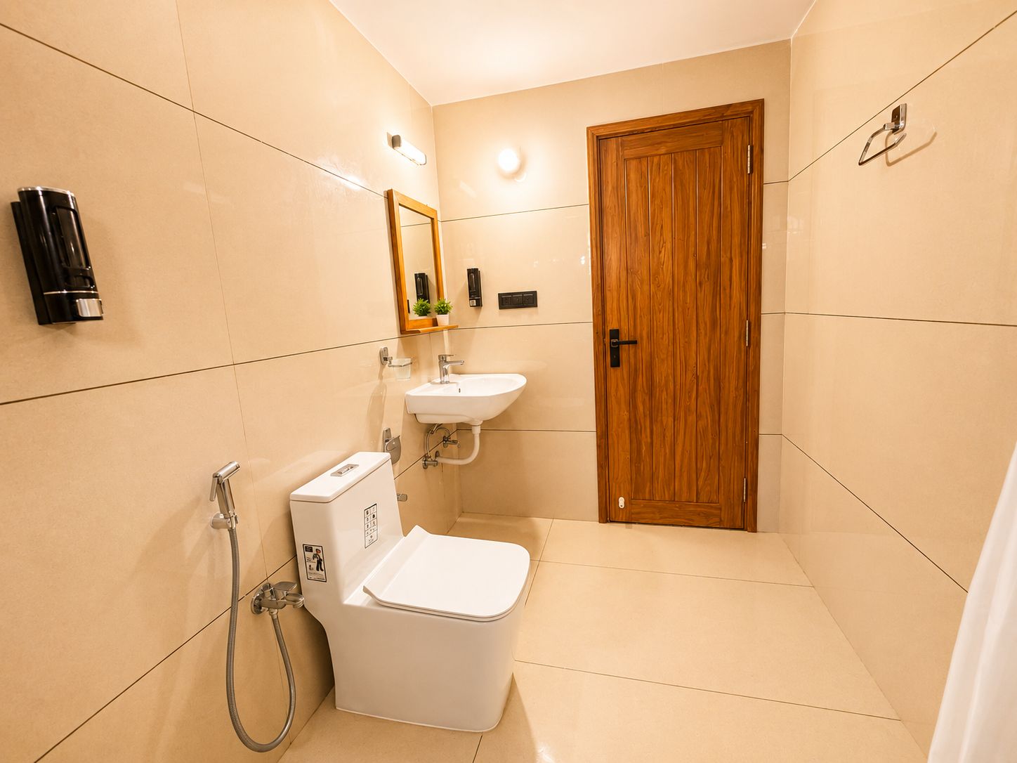 A compact bathroom with a toilet, sink, and shower.