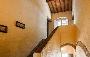 A narrow staircase with a wooden handrail leading to a doorway. - Nice home in Poggibonsi with swimming pool (Poggibonsi)