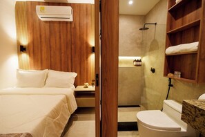A hotel room with a bed, bedside table, and a wooden panel wall. - Hotel W Santa Marta (Santa Marta)