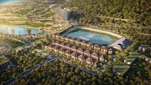 A resort with a central pool, multiple guest buildings, and surrounding greenery. - Swiss-belvillas Solavita Binh Tien (Cong Hai)