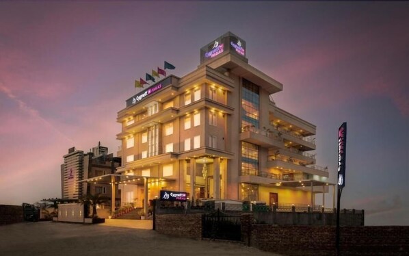 A multi-story hotel with a prominent sign for 'Sygma Hotel' and 'Sygma Parlor'. - Cygnett Inn Paras Trademark by Wyndham (Dehradun)