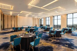 A conference room with round tables, chairs, and a carpeted floor. - Fortune Walkway Mall Haldwani (Haldwani)