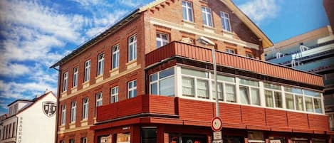 A red-brick building with a storefront and a sign that reads 'Superdr'.