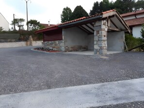 A building with a stone foundation and a red roof.