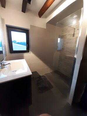 A modern bathroom with a large sink, a window with a view, and a glass shower enclosure. - Holiday Home "Maison Gau Argi2" with Wi-Fi (Armendarits)