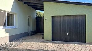 A building with a garage door, a window, and a door.