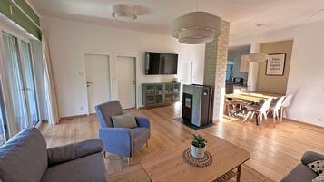 A modern living room with a sofa set, a coffee table, and a TV.