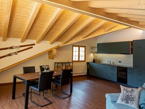 A modern loft-style kitchen with a dining area and a cozy seating space. - Haus Abäsonne Appartement/Fewo, Bad, WC, 1 Schlafraum 2.5 Zimmerwohnung by Interhome (Adelboden)