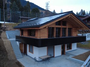 A modern two-story house with a flat roof, large windows, and a balcony. - Haus Bettina Appartement/Fewo, Dusche, WC, 4 oder mehr Schlafräume by Interhome (Adelboden)