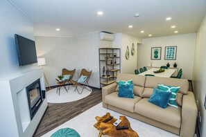 A modern living room with a sofa, chairs, a coffee table, and a dining area with a table and chairs. - ATLANTIC SUN HOUSE - THE INSPIRATION FOR THE GIANT WAVES OF NAZARÉ!!! (Nazaré)
