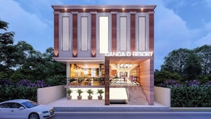 Un edificio moderno con un letrero que dice 'GANGA D RESORT'.