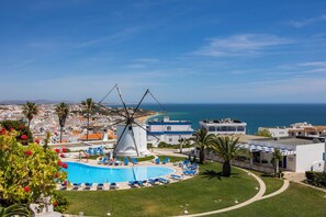 A coastal resort with a windmill, a swimming pool, and beach views. - Spacious 2 bed 2 bath apartment in beautiful Windmill Hill complex with Air Con. (Albufeira)