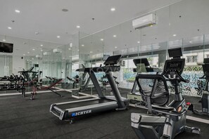 Een moderne sportschool met loopbanden, elliptische trainers en gewichten.