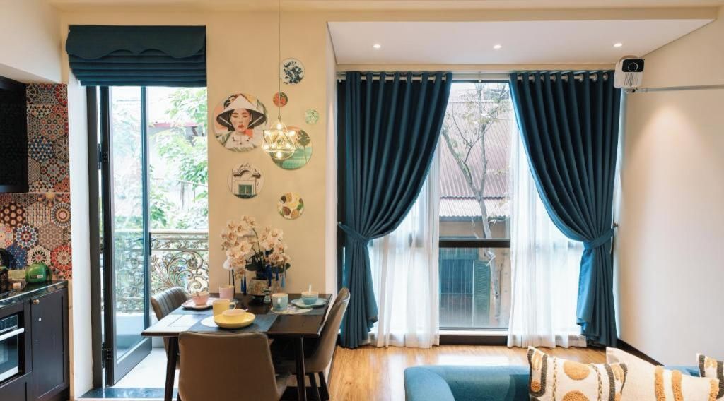 A dining area with a table, chairs, and a view of the outdoors.