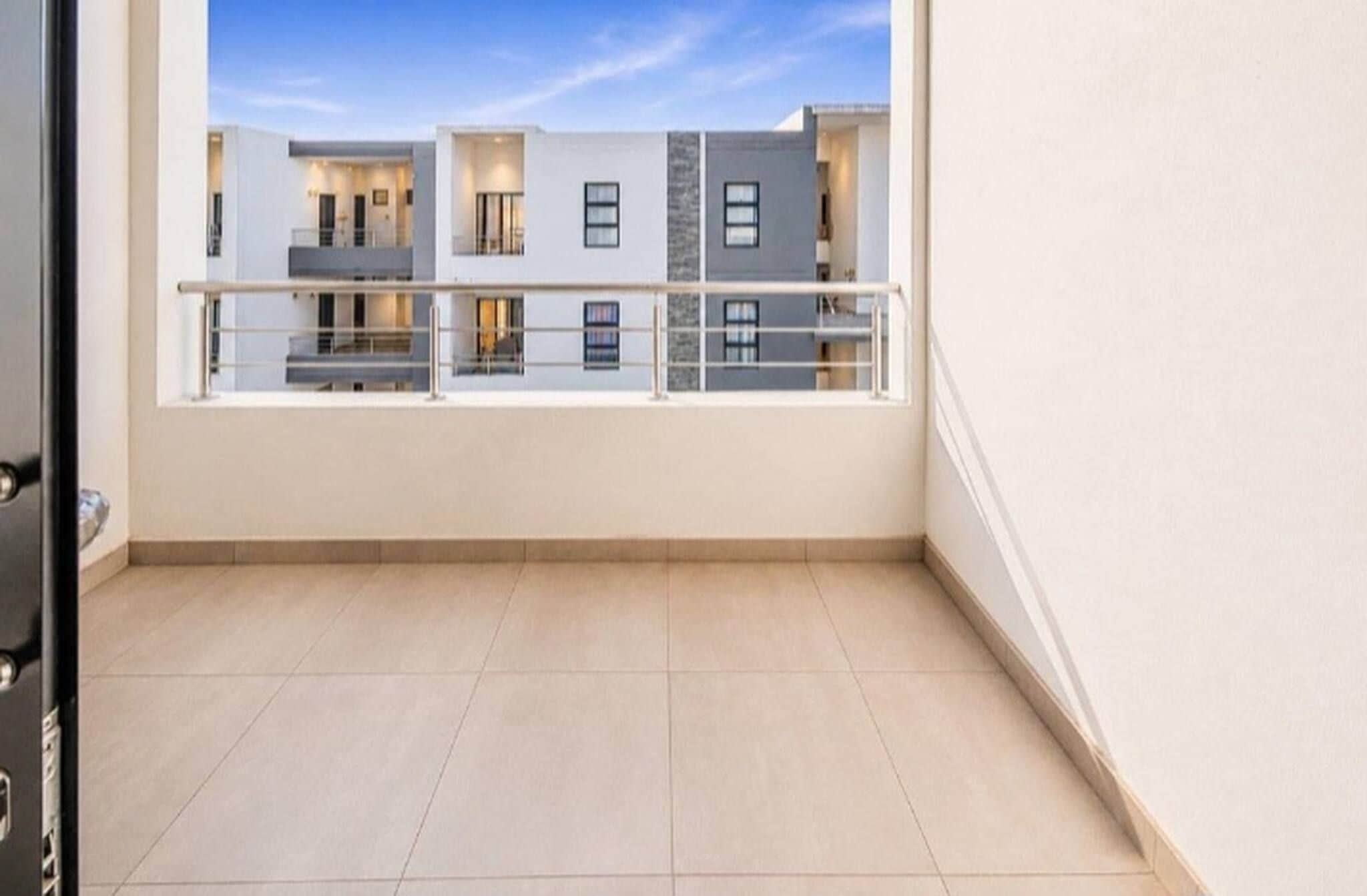A balcony with a view of a modern building.