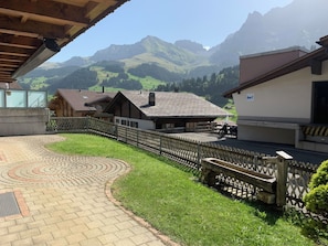A courtyard with a paved walkway, wooden fences, and buildings with traditional architecture. - Alpenglühn Appartement/Fewo, Bad, WC, 3 Schlafräume by Interhome (Adelboden)