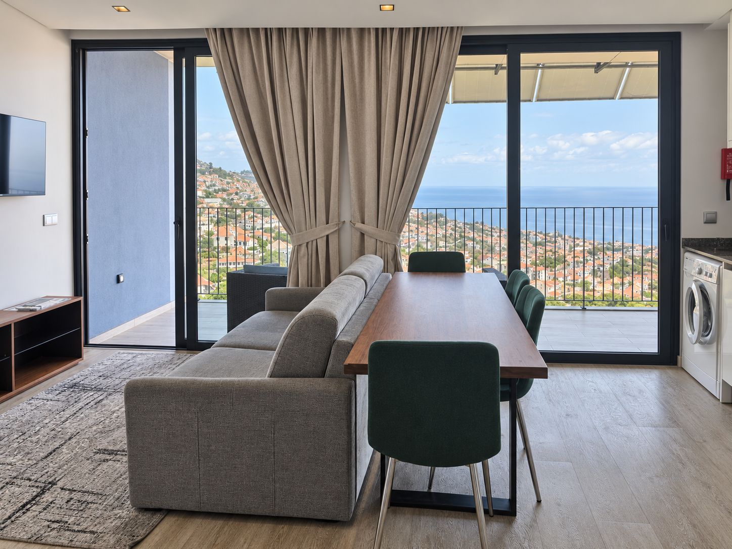 A modern living room with a sofa, chairs, and a dining table.