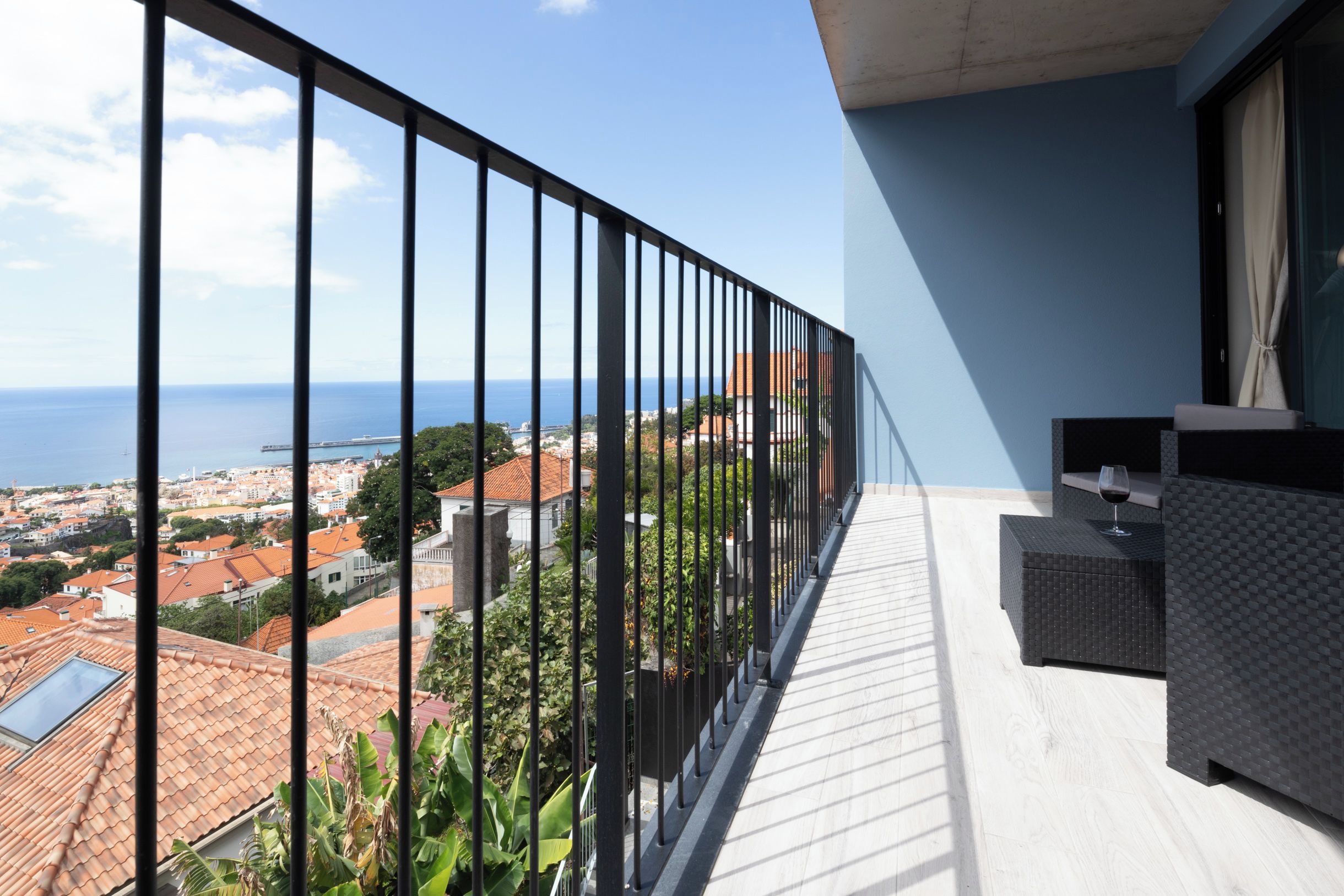 Een balkon met uitzicht op zee en het stadsbeeld.