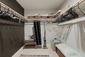 A compact bedroom with a bunk bed, a small desk, a vacuum cleaner, and a storage unit. - Cozy Rustic Retreat with Pool in the heart of Sac (Sacramento)