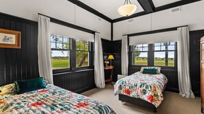 A room with two beds, large windows, a lamp, and a picture on the wall. - Byfrons Phillip Island Road (Cowes)