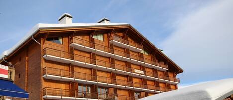 A multi-story wooden building with balconies, likely a hotel or lodge.