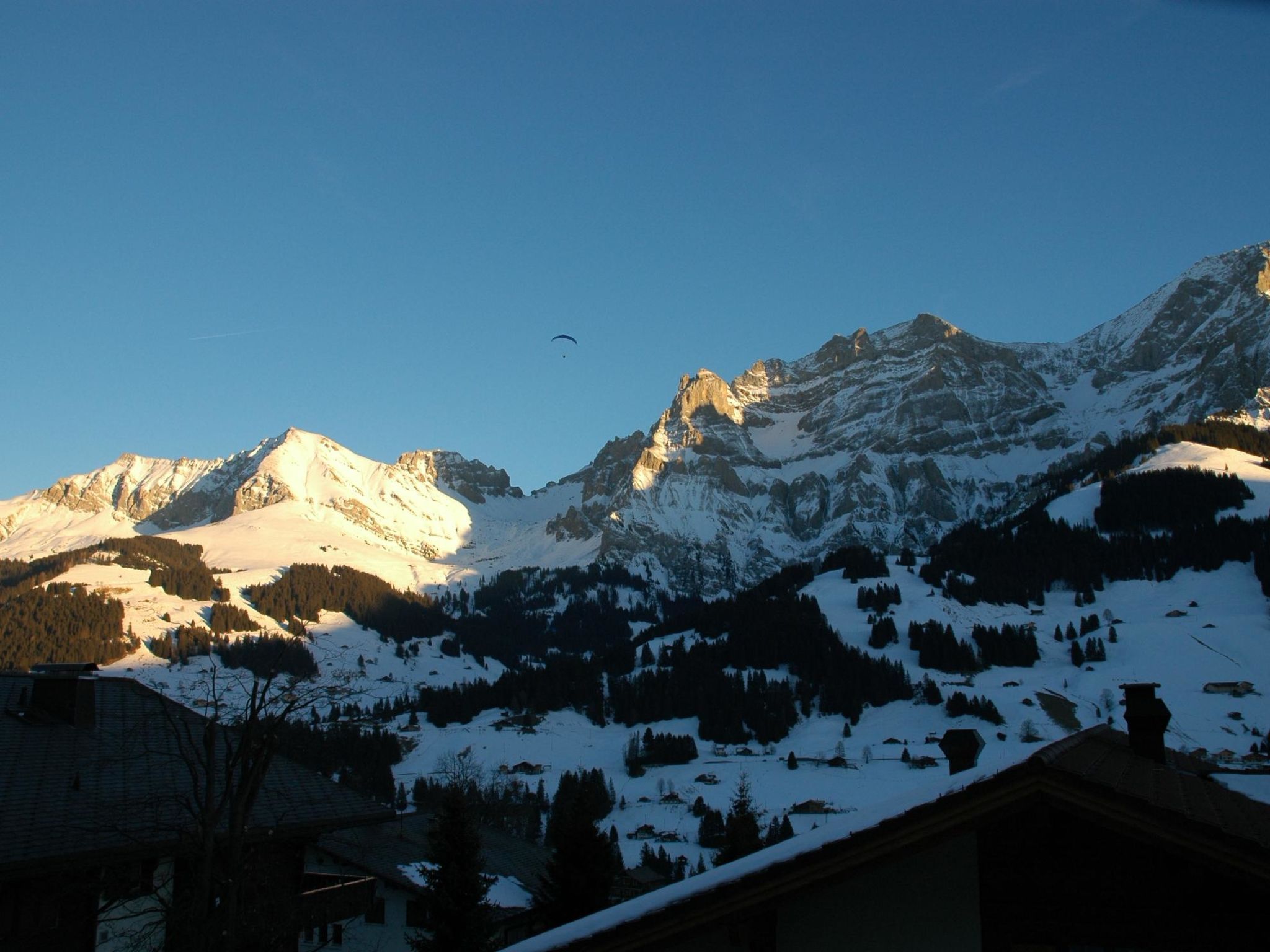 Un paysage de montagne avec des sommets enneigés et un ciel dégagé.