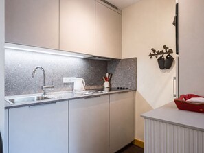 A modern kitchen with a stainless steel sink, a kettle, and a coffee machine. - Apartment at the slopes - 4 guests (Val-d'Isère)