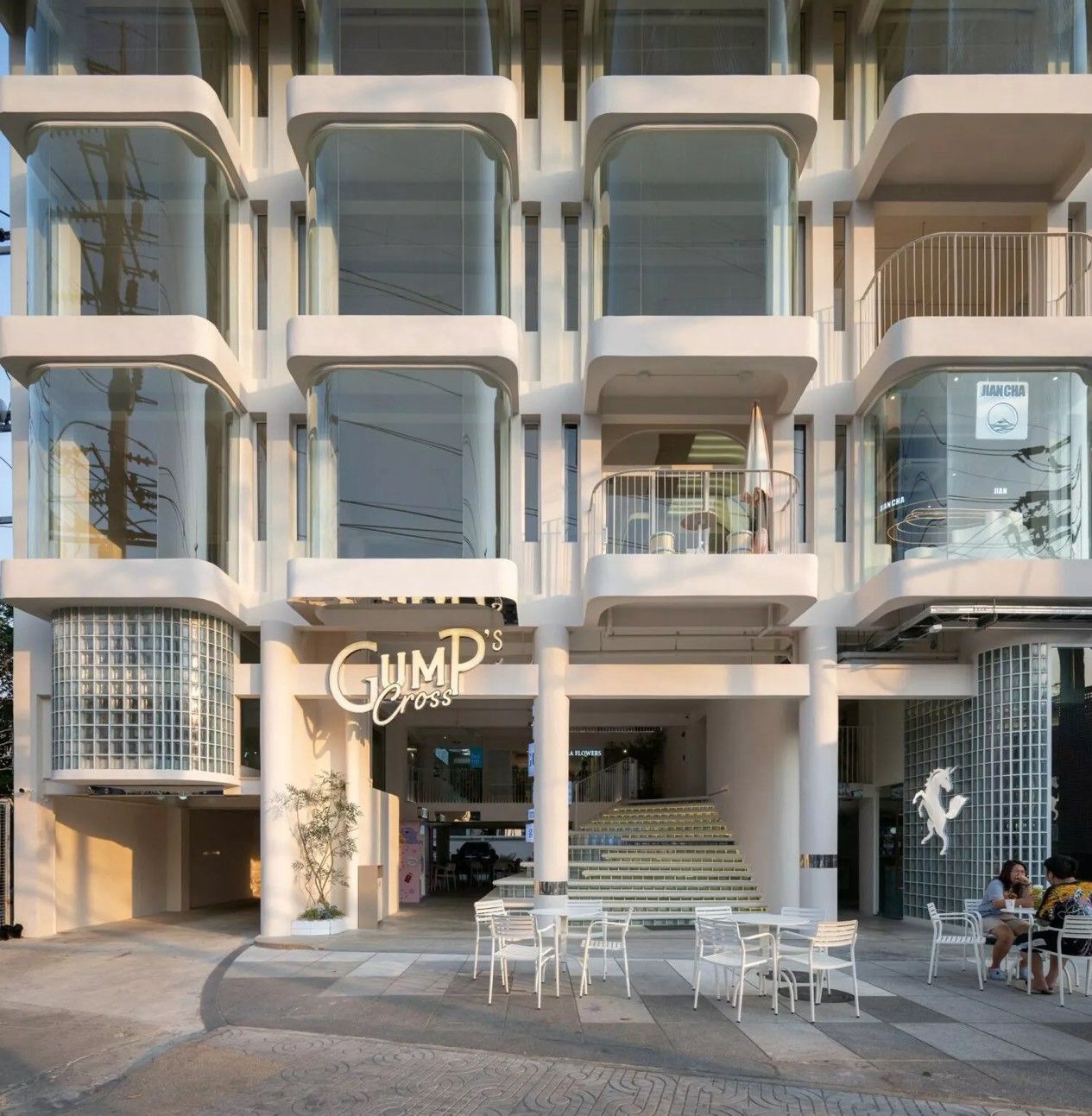 A modern building with a storefront named 'GUMPS Cross.'