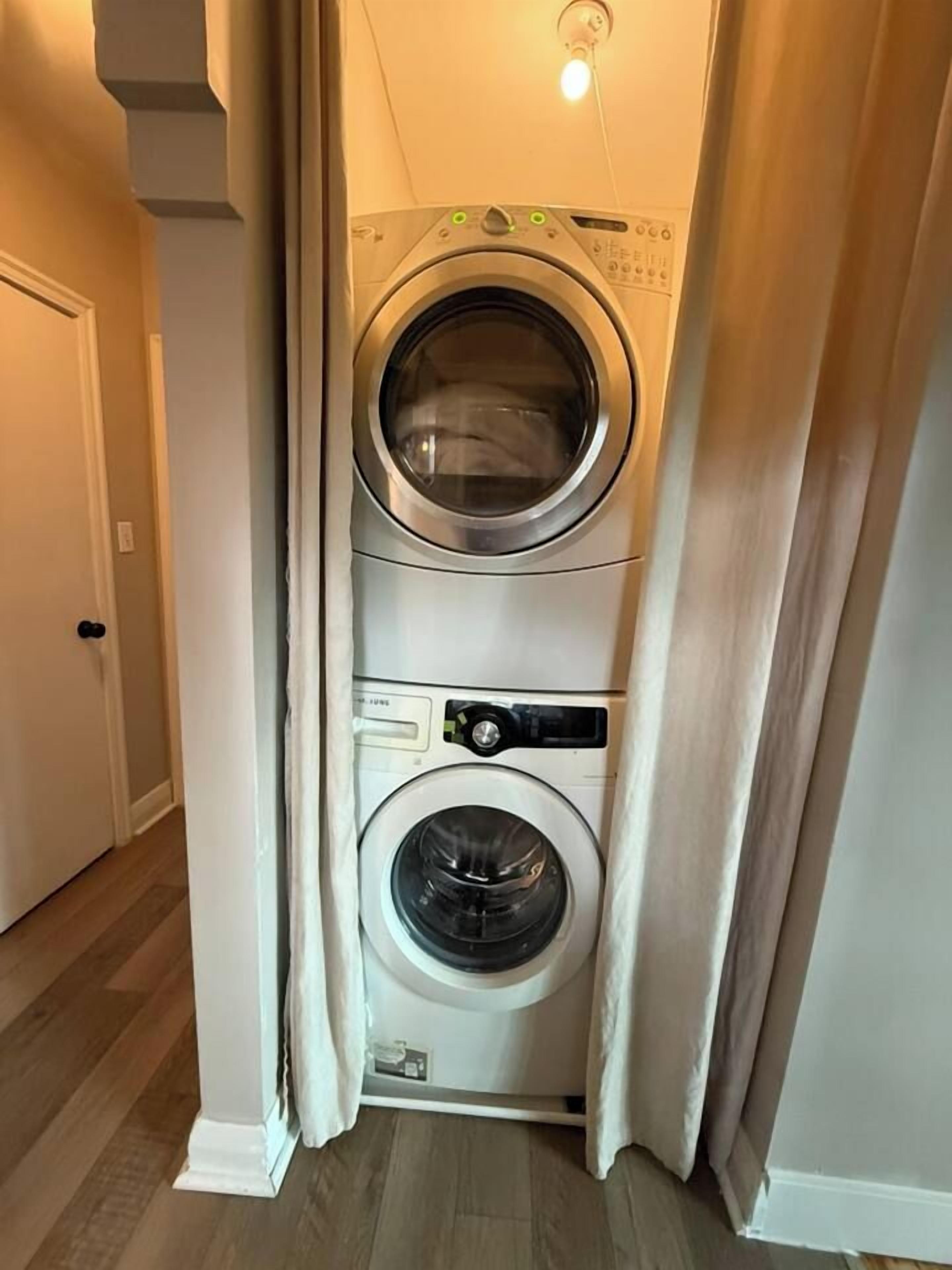 A laundry room with two stacked front-loading washing machines.