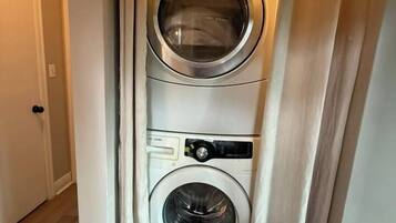 A laundry room with two stacked front-loading washing machines.