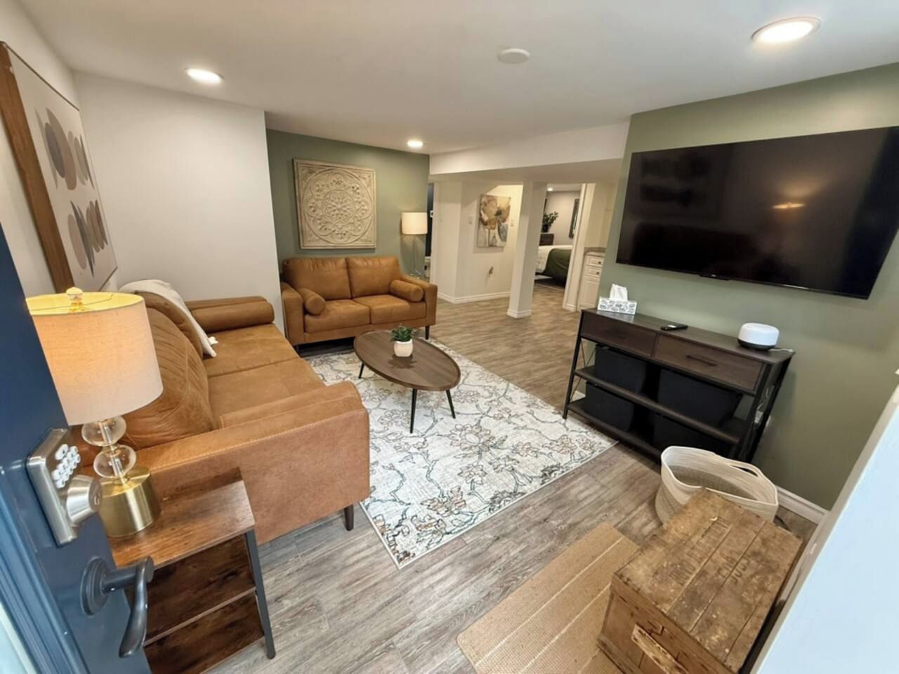 A living room with a sofa, coffee table, and a TV.