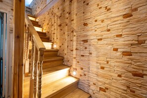 Eine Holztreppe mit einer Steinmauer an der Seite.