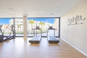 A gym with treadmills, a stationary bike, and a rowing machine. - Bahia La Cala Paradise And Sunshine (Mijas)