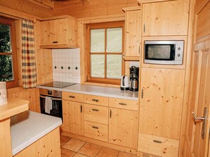 A wooden cabin-style kitchen with a window, a microwave, and a coffee maker. - Wonderful private villa for 8 people with WIFI, TV, terrace, pets allowed and panoramic view (Mandling)