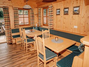 A wooden cabin interior with a dining area, benches, and a view of the outdoors. - Wonderful private villa for 8 people with WIFI, TV, terrace, pets allowed and panoramic view (Mandling)
