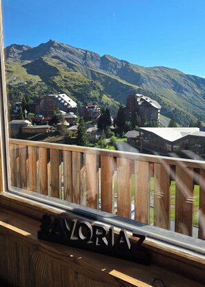 A wooden balcony with a view of a mountainous landscape and buildings. - L'Ultime 1800 - Avoriaz - Sleeps 6 - Premium (Morzine)