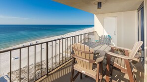 A balcony with a view of a beach and ocean. - Phoenix I 1113 2 Bedroom Condo (Orange Beach)