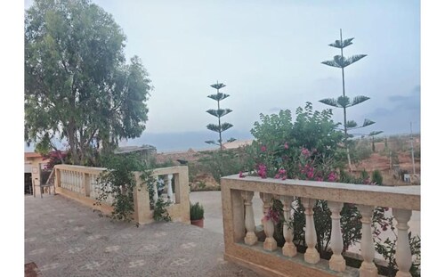 A paradise with a pool and views of the sea and mountains.