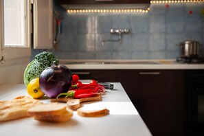 A kitchen counter with vegetables and bread. - Two Minutes from Florence Cathedral   San Lorenzo Terrace (FIRENZE)