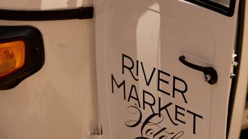 A vehicle with a door labeled 'RIVER MARKET Hotel'.