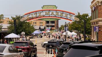 A busy street with a historic archway labeled 'Kansas City' and '1857' indicating the city's establishment year.