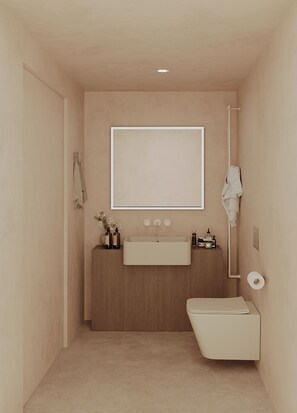 Un baño pequeño con lavamanos, espejo e inodoro.