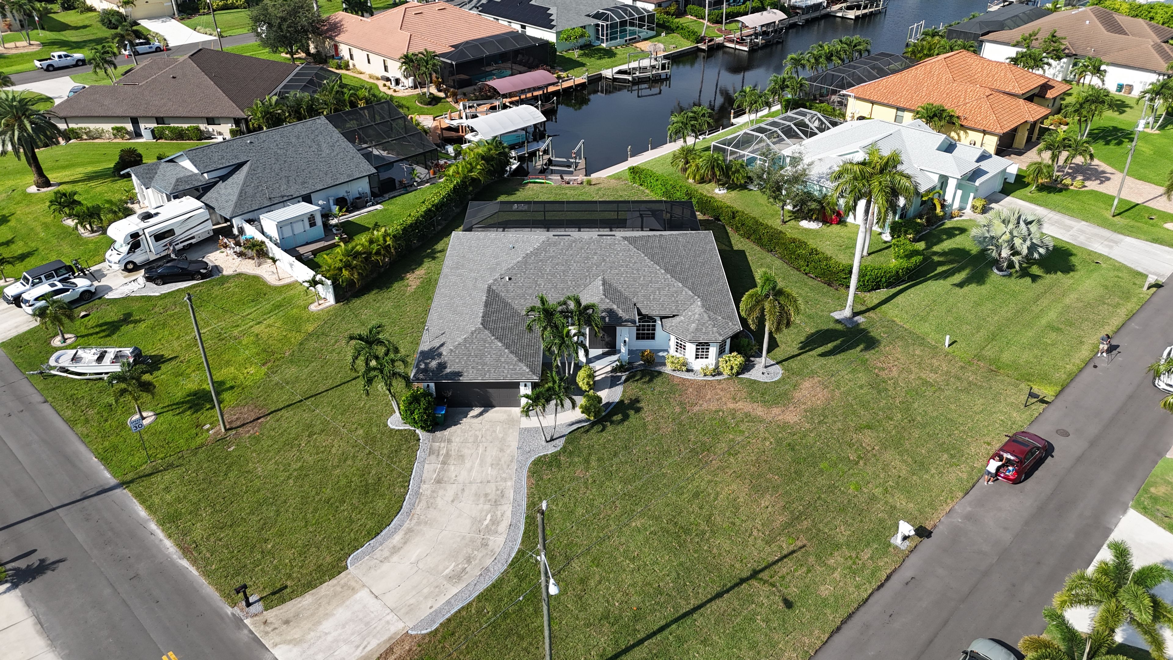 A residential area with houses, a boat dock, and a clear sky.