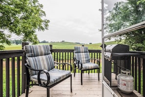 A porch with two striped chairs and a grill. - Tango Spring (Cranberry Township)